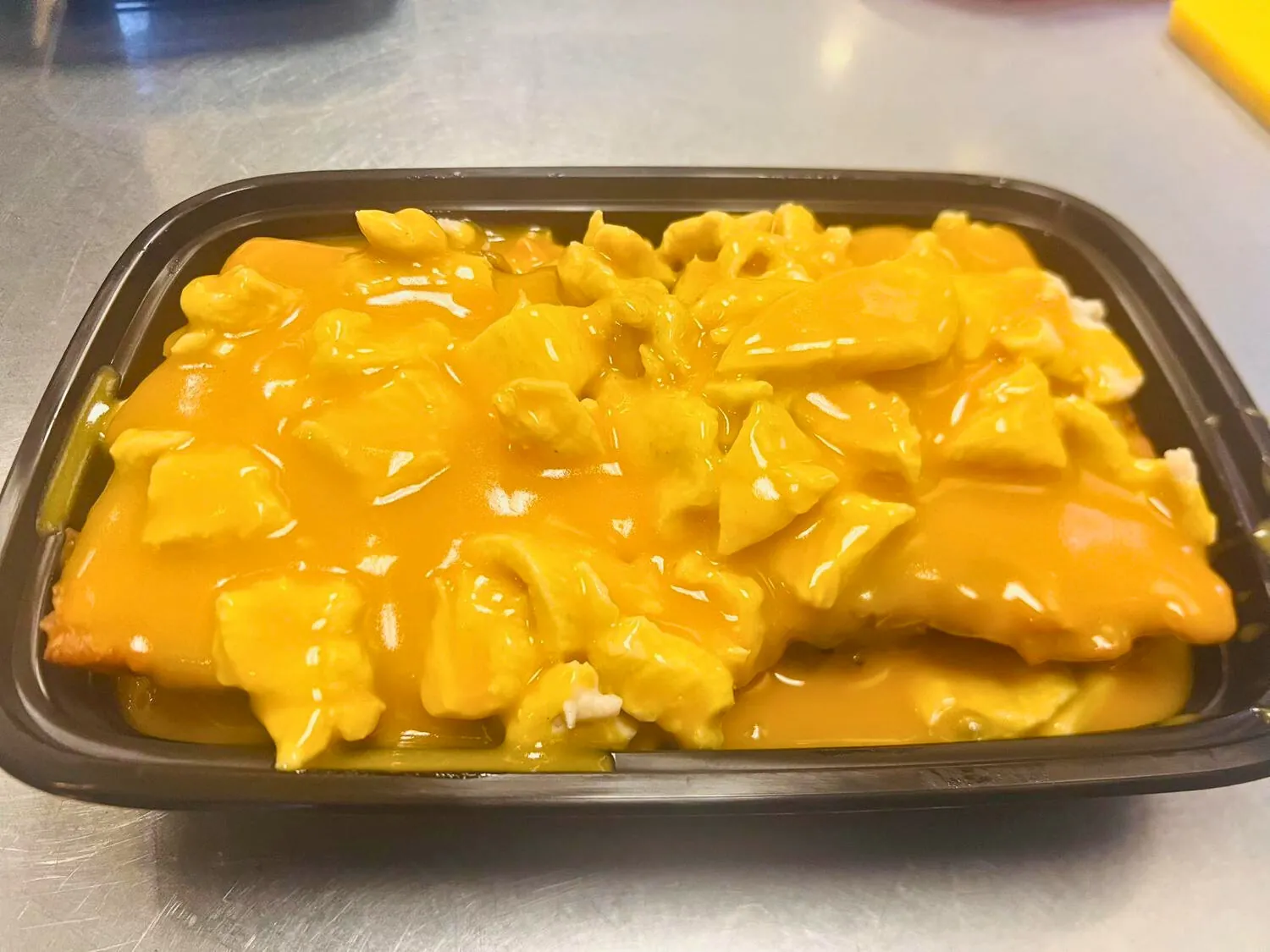 Description: Fluffy egg foo young with chicken and savory sauce at Wok's Cookin', a Chinese Restaurant in Castaic